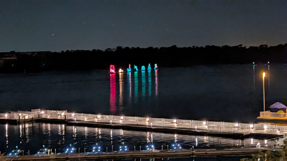 A view of the Electrical Water Pageant at the Walt Disney World Resort from the skywalk bridge from the Contemporary Resort to Bay Lake Tower. 