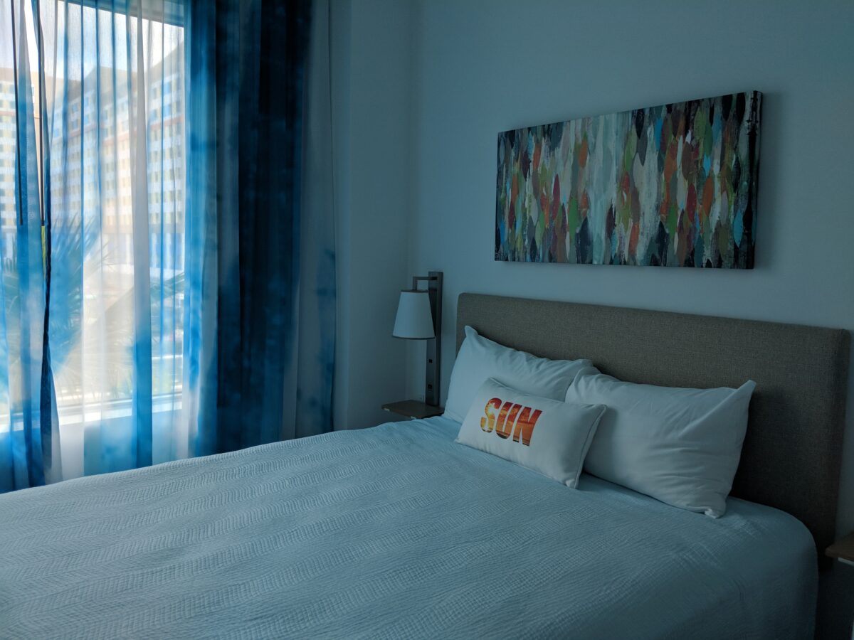 A picture of a guest room with a queen bed at two-bedroom suite at Universal's Endless Summer: Surfside Inn