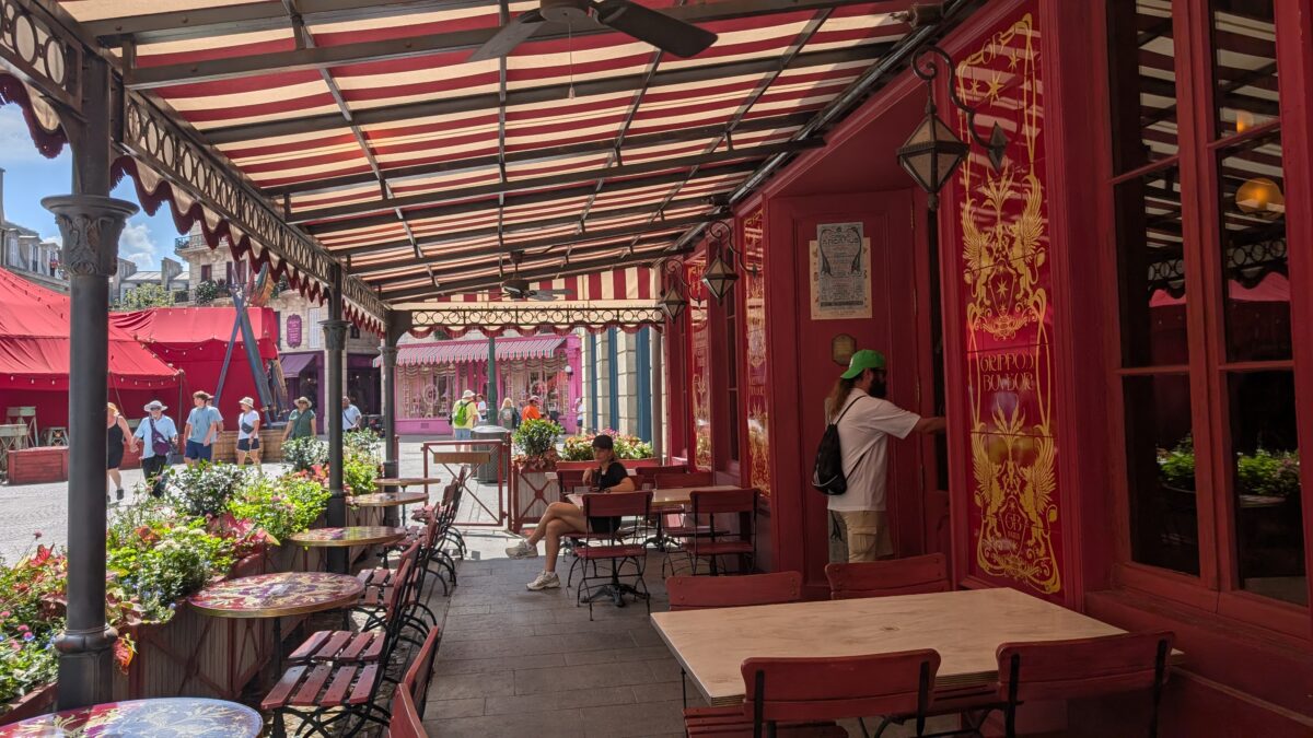 Outdoor seating at Café L’air De La Sirène restaurant in Epic Universe's Ministry of Magic