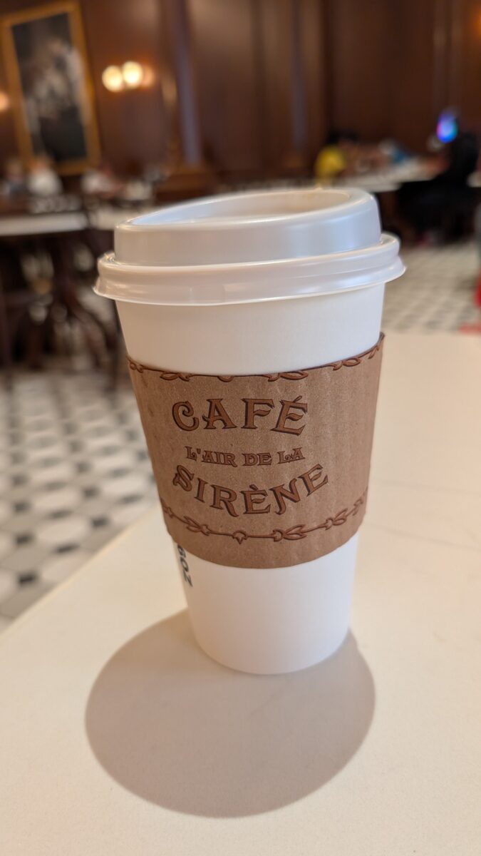 A picture of a coffee from Café L'air De La Sirene, a restaurant at the Wizarding World of Harry Potter Ministry of Magic section of Universal Orlando's Epic Universe theme park.